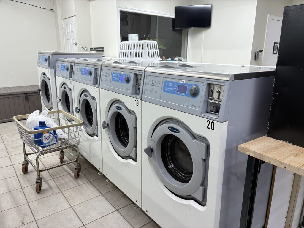 Washers along the wall at Jane Coin Laundry